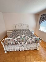 King white metal Victorian bed with floral mattress and two matching nightstands