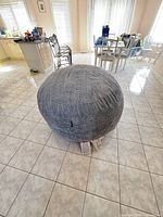 Full view of gray faux fur bean bag in room