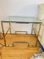 Front view showing full table including frame design and glass top