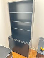 front view showing shelves and cabinet