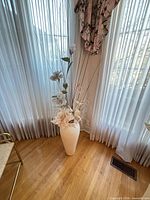 Full view of vase with floral arrangement in room setting