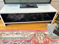 Front view of white TV stand with open shelf