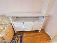 Front view of white sideboard between sofas, cabinets closed