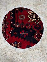 Full view of the circular Bakhtiyar rug showing overall pattern and fringe