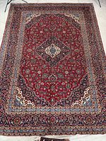 Full top-down view of the Kashan rug showing overall pattern and condition