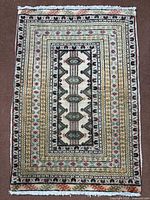 Full view of Torkaman rug showing overall pattern, colours and fringe