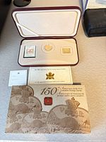 Open presentation case showing coin, stamp, medallion, certificate
