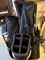Golf bag with divider top next to black travel cover