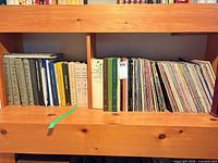 Full shelf view showing bulk of vinyl records and sleeves