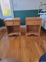 Front view of both pine nightstands showing drawer, open shelf and finish