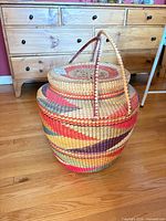 lidded multicolour woven basket with handles front view