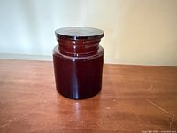 Front view of amber glass jar with lid on