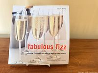 Front cover displaying title, author, champagne flute imagery
