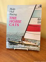 Front cover of paperback showing title and sailboat image
