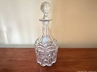 Full view of crystal decanter with stopper