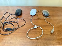 All three wired USB mice laid out showing cables and USB-A connectors