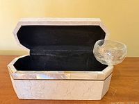 Lid open showing black felt interior and inlay edge