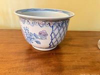 Side view showing floral and lattice pattern on cachepot