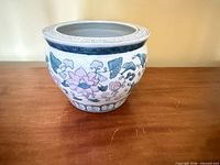 Front view of round porcelain planter with Asian floral and geometric pattern