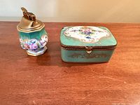 Trinket box closed beside table lighter front view