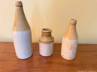 Front view of three stoneware vessels showing shapes and glaze