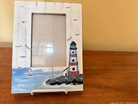 Front view showing painted lighthouse design and 4x6 opening