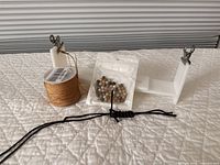 Paracord jig, gemstone beads bag, spool of braided cord displayed on surface