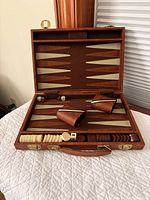 Open case showing board, dice cups, checkers and dice