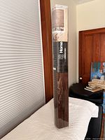 Packaged walnut bamboo blind standing upright