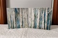 Front view of both birch tree canvas prints on bed