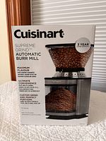 Front view of boxed Cuisinart Supreme Grind Automatic Burr Mill