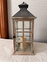 Front view of wood and glass lantern with LED candle inside