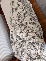 Duvet cover laid out showing overall gray leaf pattern