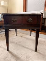 front view showing drawer, legs, finish wear