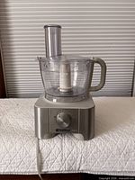 Front view of Kenmore MultiPro food processor showing base, control dial, work bowl, lid, and feed tube