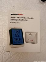 Retail box showing product name, model TP-65, and images of display unit and sensor