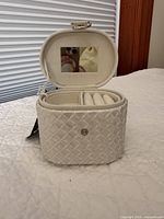 Case open showing interior mirror, ring rolls, removable tray