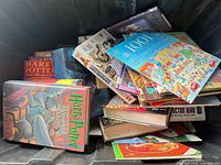 Bin filled with Harry Potter hardcovers, LEGO Chima book, Doctor Who book and other children’s titles