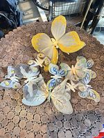 Group of assorted decorative fabric butterflies on tabletop