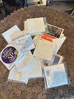 Pile of assorted guitar string sets and individual string packets showing Martin Lifespan SP and Savarez Alliance packaging
