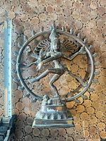 Full view of Nataraja statue next to ruler showing height