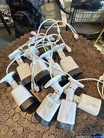 Group of seven Hisense bullet security cameras showing mounts and cable leads