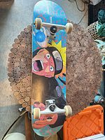 Top view of complete skateboard with Naruto graphic and trucks/wheels visible