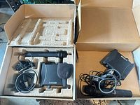 Two boxes with receivers, microphones and cables