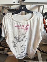 Front of Magnolia Pearl tee showing text and portrait graphic