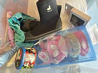 Overview showing neoprene boots, Cabbage Patch doll in case, Mickey Mouse tin, hair accessories and boxed item