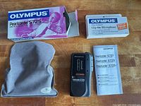 Recorder, microphone box, pouch, manual and product box on table