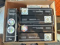 Cardboard box containing seven boxed stepping stone kits