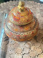 Jar with lid showing overall design and ruler for scale