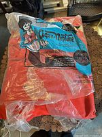 Front view of sealed Aqua-Neptune orange life jacket in original bilingual packaging